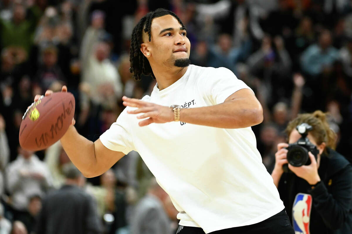 Ohio State's C.J. Stroud throws out a signed football during the first half of a game between the Utah Jazz and Dallas Mavericks at Vivint Arena on January 28, 2023 in Salt Lake City, Utah. Stroud, who is a possibility for the Texans near the top of the NFL draft, will throw at the combine Saturday.