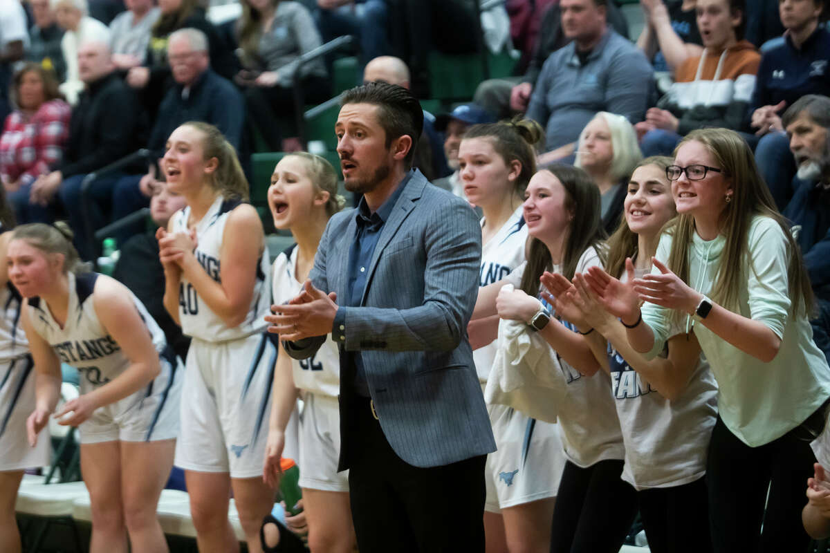 Meridian coach Tanner Smith encourages the Mustangs during a March 8, 2022 regional semifinal against McBain.