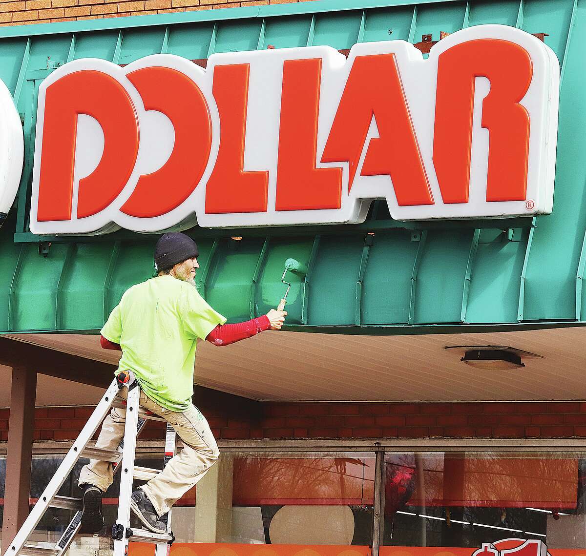 A worker with Tolliver Quick Fix from Granite City was working under a dollar Wednesday - a dollar sign that is, where he and a co-worker were painting on the awning front at the Family Dollar store in Washington Plaza. No big changes were made in the appearance, just a similar shade of green.