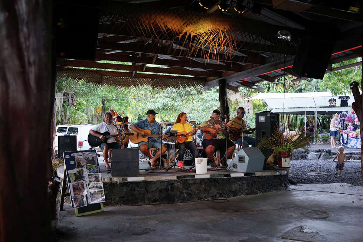 Performers at Uncle Robert's night market play Hawaiian music and island versions of other songs in a kanikapila-style jam session.