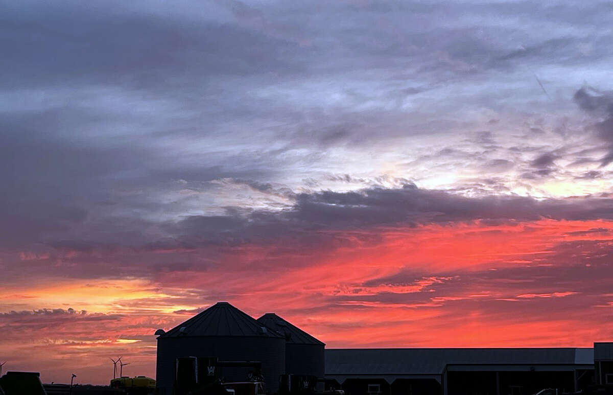 Wispy clouds add dark highlights to a colorful sunset.