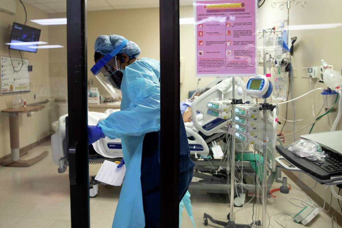 In a file photo: Eboni Windom, a respiratory therapist at Texas Vista Medical Center, attends to a COVID patient in the ICU.