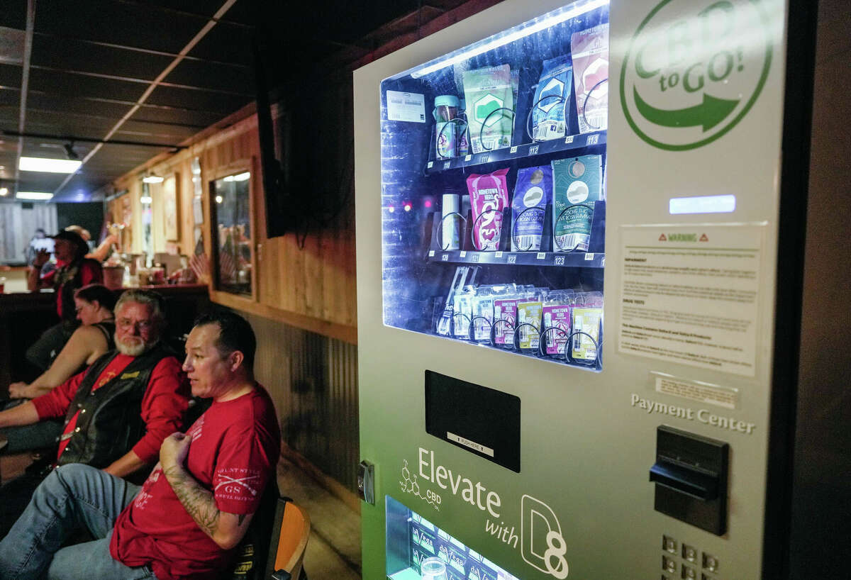 Veterans Chris Luna and Carl Arnold eat steak dinners beside a Delta 8 vending machine located in the Tomball VFW Post 2427 on Friday, Feb. 24, 2023 in Houston, TX. Research has suggested delta-8 is less potent than marijauna.