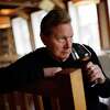 A portrait of Rex Pickett holding a glass of pinot noir at Vintner's Collective in Napa, Calif., Tuesday, Feb. 28, 2023.