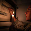 Woman checking fuse box at home during power outage or blackout. No electricity concept. High quality photo