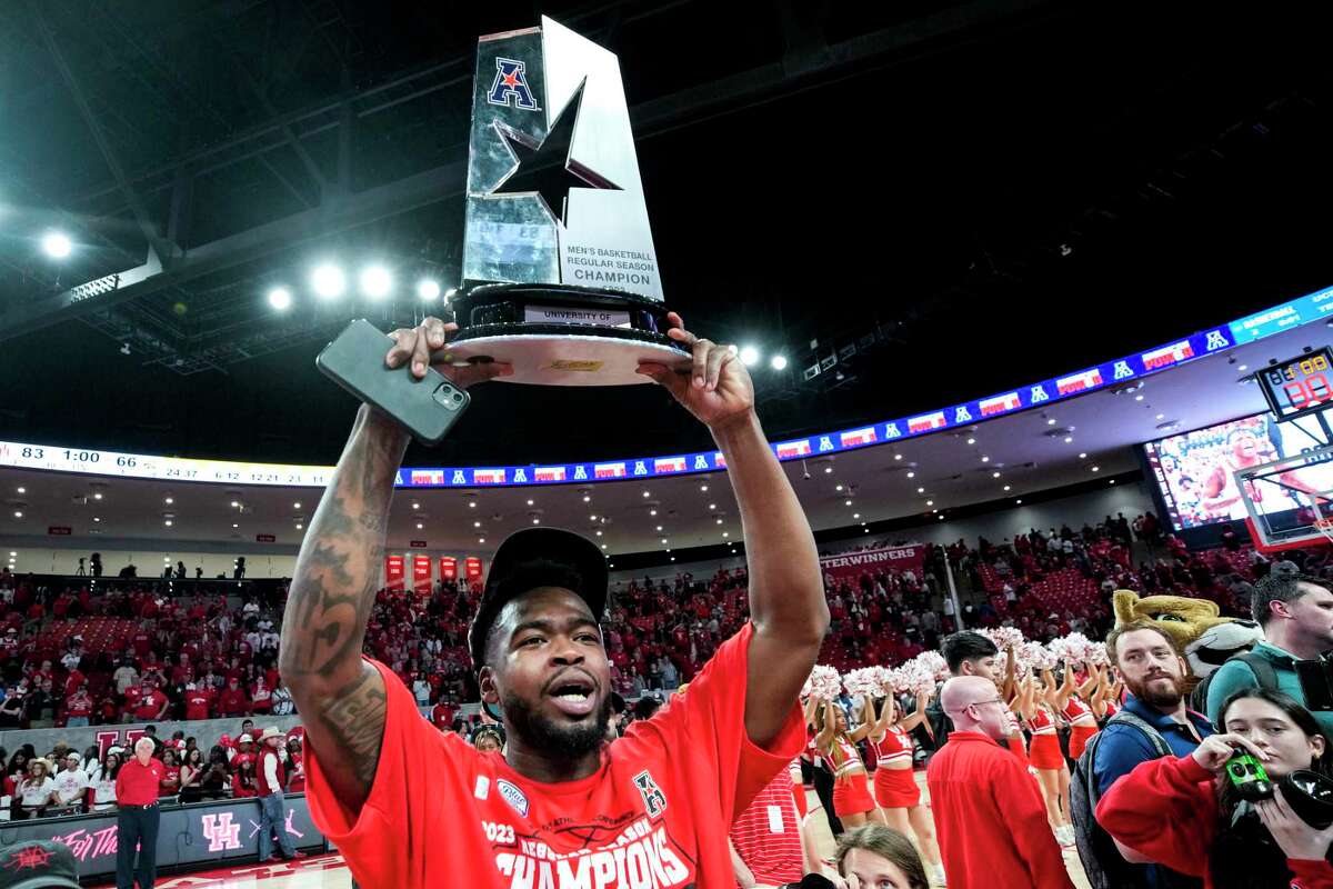 Houston guard Jamal Shead raises the AAC trophy after the Cougars beat Wichita State.