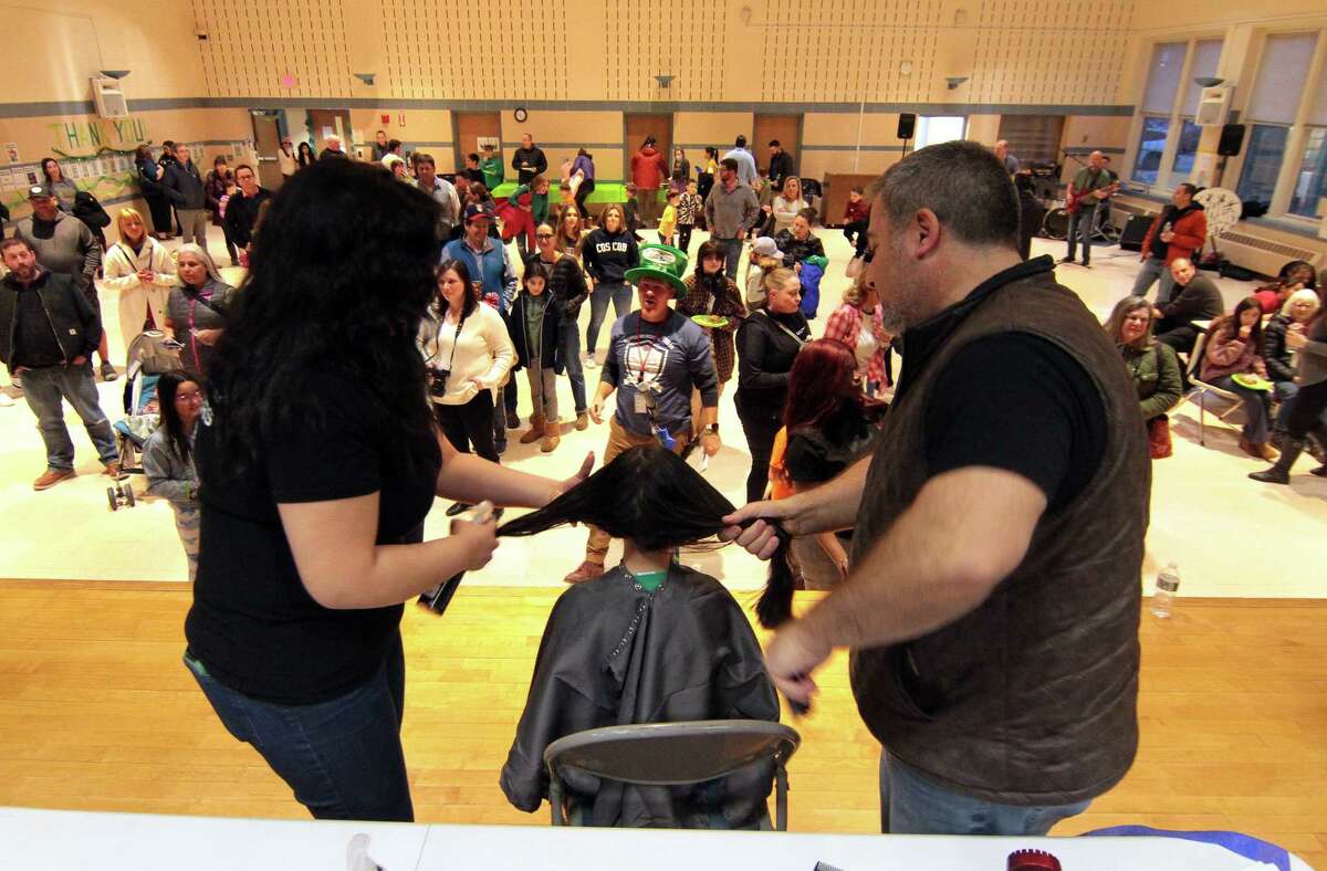 Cos Cob Elementary School hosts a head shaving/hair donating event to raise awareness and money for childhood cancer research and the St. Baldrick's Foundation at the school in Greenwich, Conn., on Thursday March 2, 2023. This volunteer-driven event was held in an attempt to show solidarity with the children who lose their hair undergoing treatment and featured professional barbers, catering, and the live band The Sound Cats. Also, participants donated their ponytails (eight-inch minimum). The St. Baldrick's Foundation event has been an annual GPS tradition since 2013 and spearheaded by Cos Cob Principal Kerry Gavin.