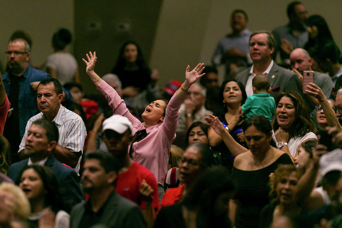 Attendees pray before President Donald Trump speaks at an "Evangelicals for Trump" campaign rally at the King Jesus International Ministry in Miami on Friday, Jan. 3, 2020.