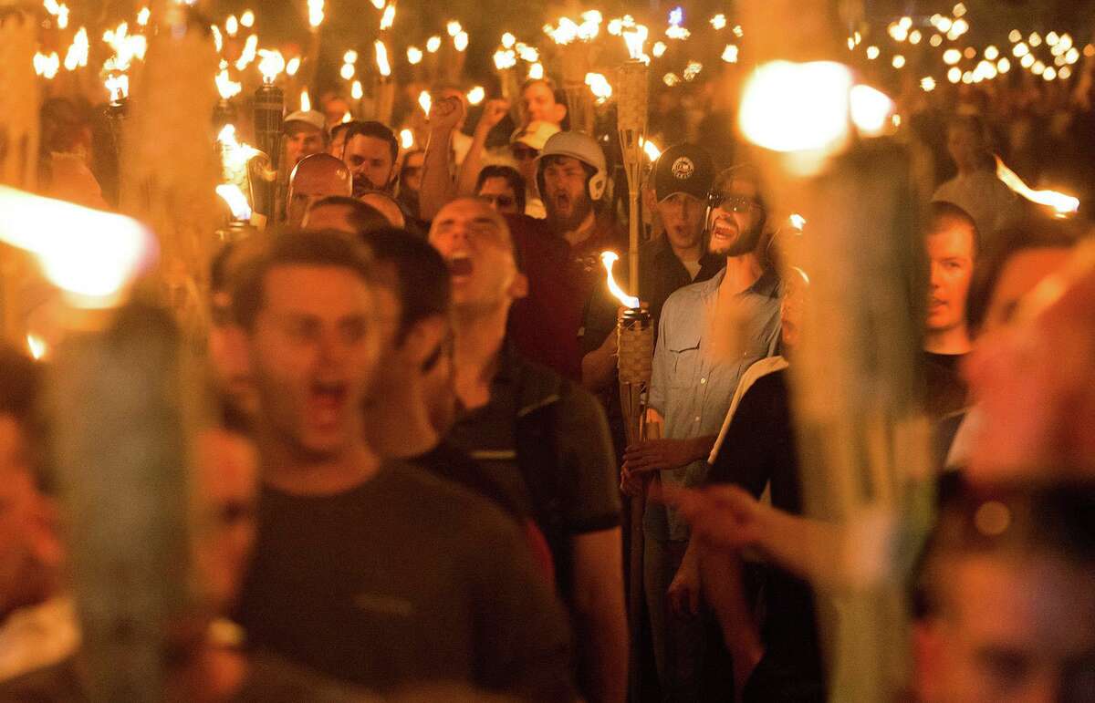 White supremacists march through the University of Virginia in Charlottesville, Va., the night before the “Unite the Right” rally, on Aug. 11, 2017.