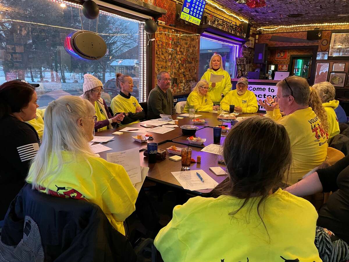 TNR Mecosta president Jennifer Thede (standing) leads the meeting at the group's regular work sessions at the Sawmill Saloon.