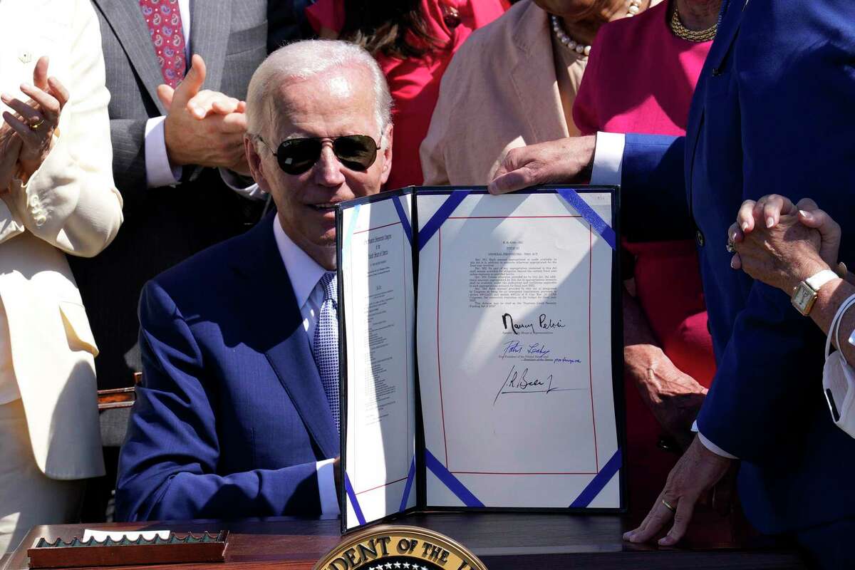 U.S. President Joe Biden signs into law the CHIPS and Science Act in 2022.