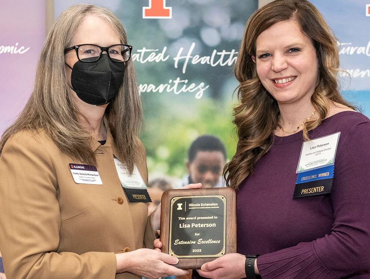 Lisa Peterson, right, has been honored by University of Illinois Extension for her excellence as a nutrition and wellness educator in central Illinois. The award was presented by Extension Director Shelly Nickols-Richardson, left.