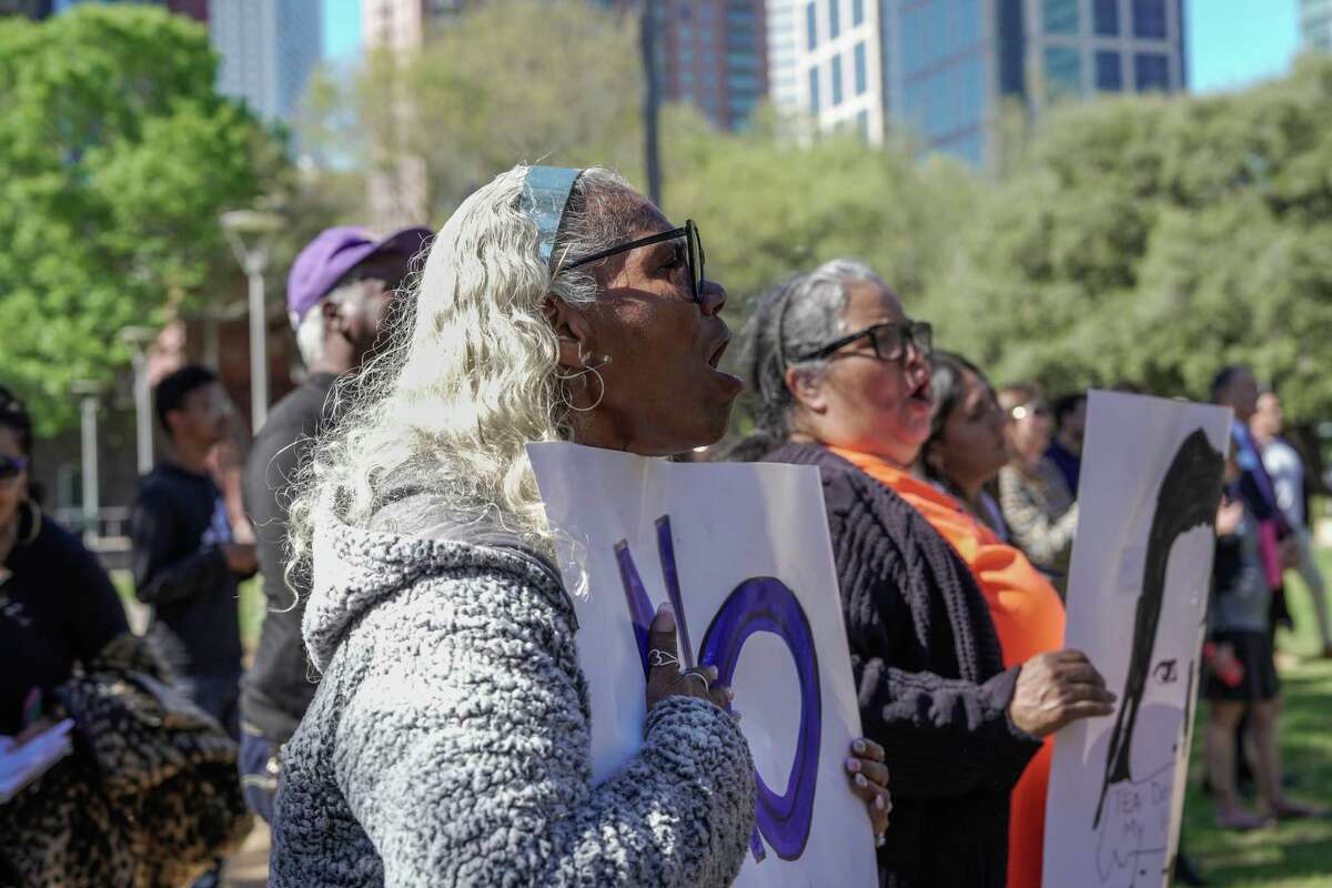Teachers Patricia Allen, 65, and Marcela Cook, 58, hold US signs at a press conference led by Mayor Sylvester Turner and other community leaders who want to save the Houston Independent School District from a state takeover and protect public education on Friday, March 3.  March 2023 in Houston, TX.