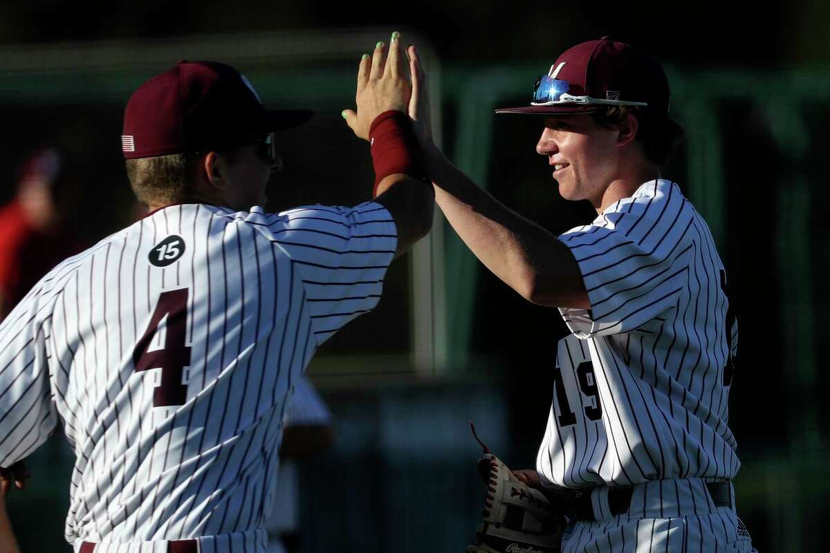 Magnolia third baseman MJ Watson (19) gets high-fives from teammates after catching Lamar Julian Benitez’s line drive in the third inning of a non-district high school baseball game at Magnolia High School, Friday, March 3, 2023, in Magnolia.