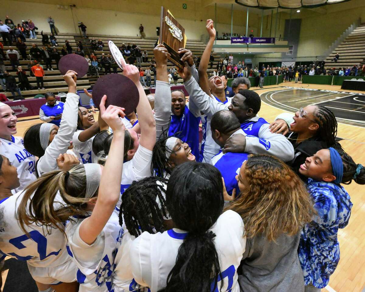 The Albany girls basketball team hoists the Section II, Class AA championship plaque after beating Bethlehem on Friday, March 3, 2023, at Hudson Valley Community College in Troy, NY.