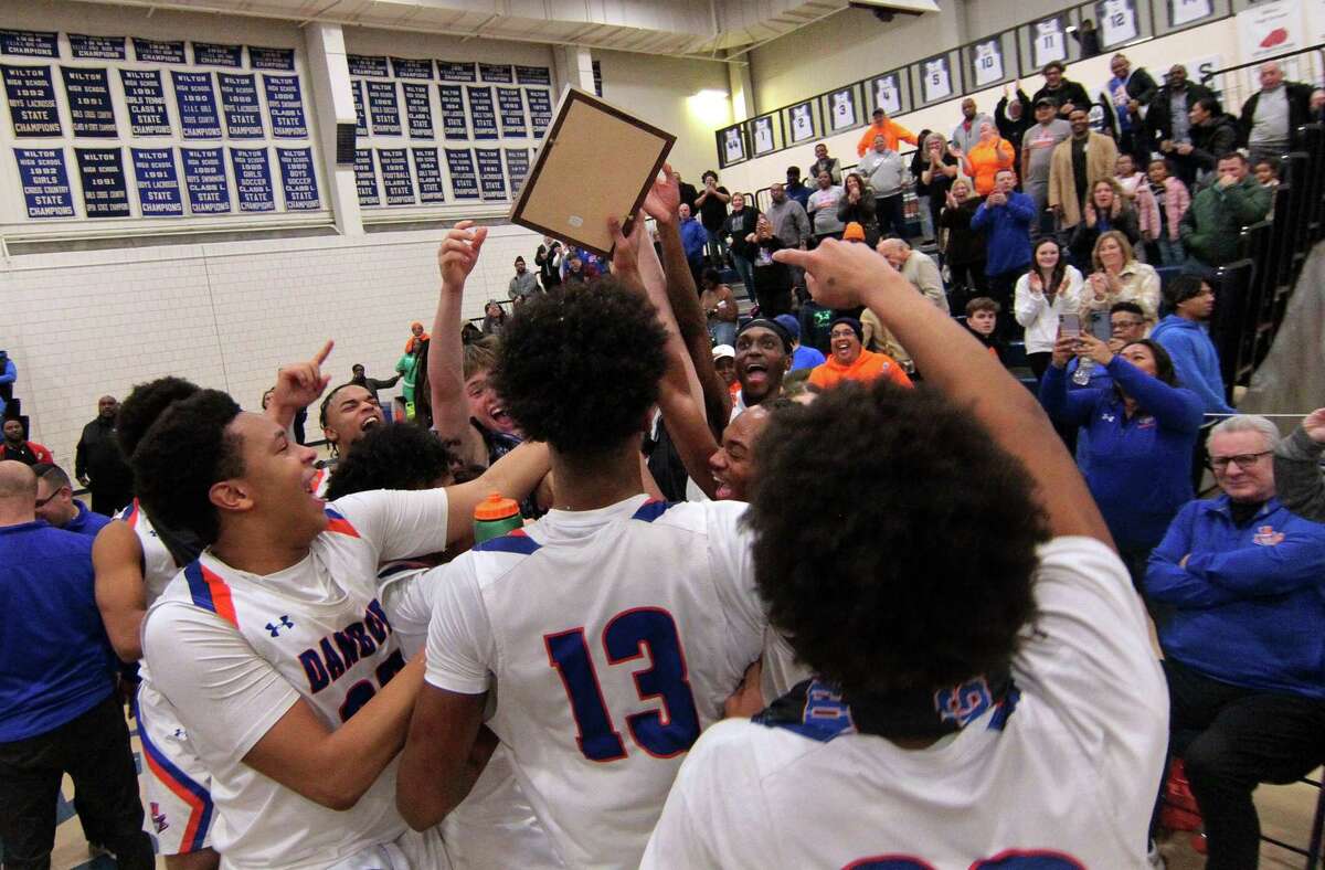 Danbury celebrates its win over Staples in FCIAC Boys' Basketball Championship game action in Wilton, Conn., on Friday March 3, 2023.