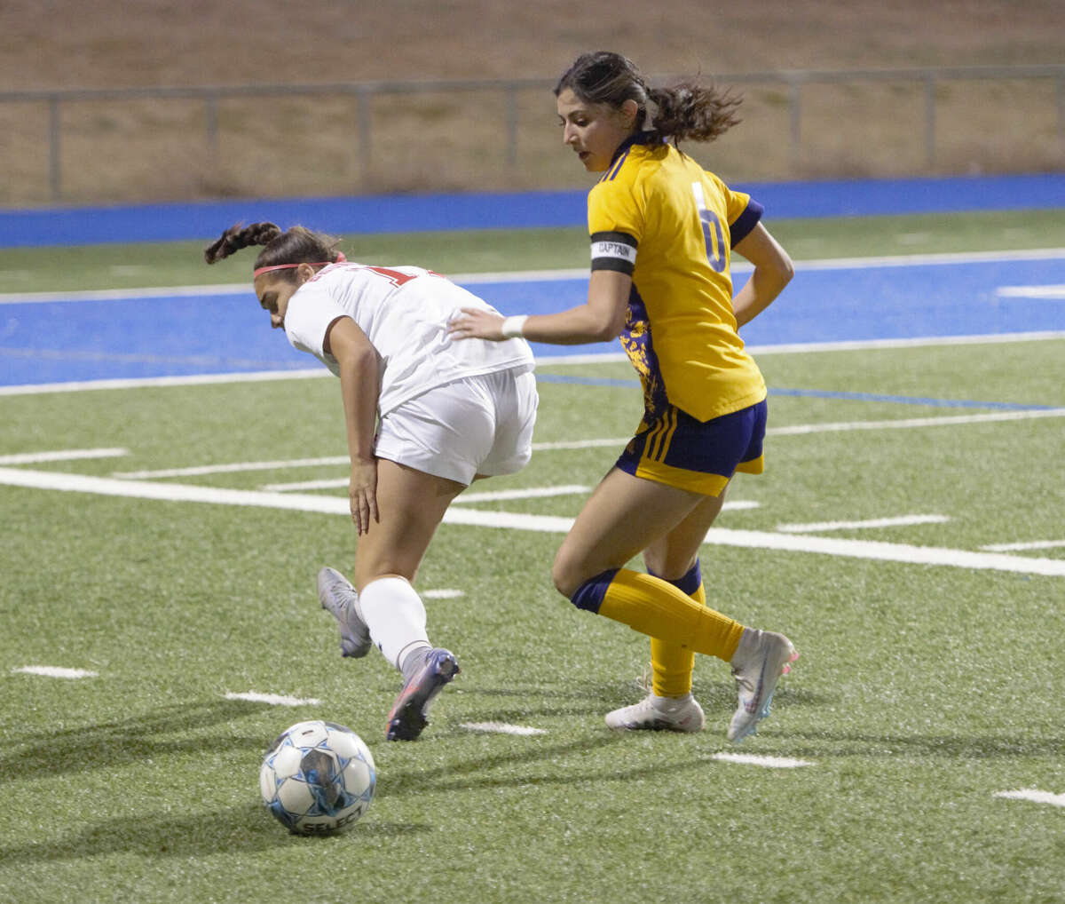 Odessa High's Paris Ray can't secure the loose ball, which allows Midland High's Melanie Sanchez to take possession during a District 2-6A girls soccer match, March 3 at Astound Broadband Stadium. 