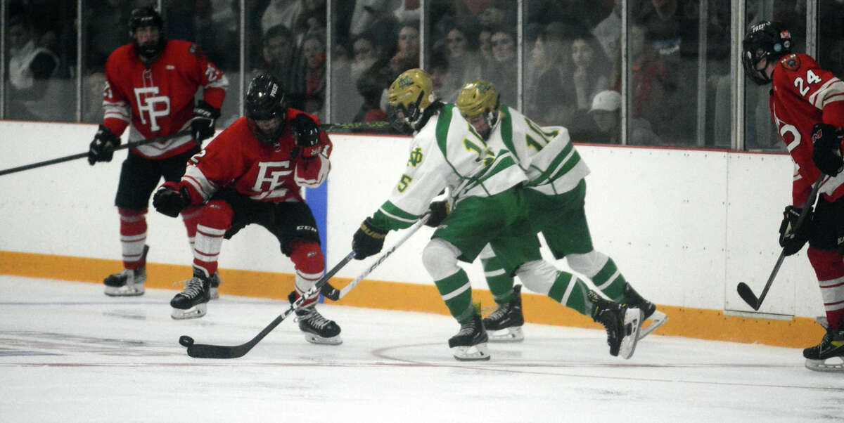 Fairfield Prep defenseman Brendan Murphy tries to stop Michael Azzarone of Notre Dame from bringing the puck up ice.