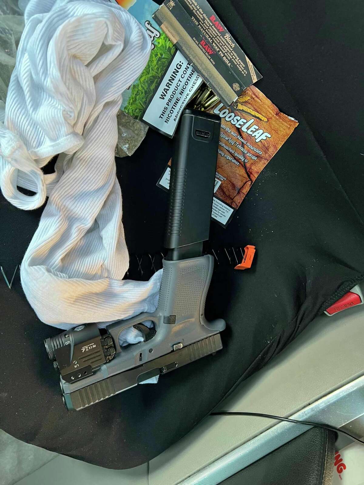 Evidence photos of drugs and guns police said they found in a car during a vandalism call in February.