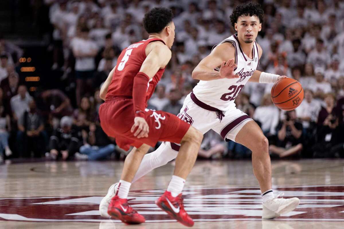 Alabama guard Jahvon Quinerly (5) attempts to guard Texas A&M guard Andre Gordon (20) in the first half of an NCAA college basketball game in College Station, Texas, Saturday, March 4, 2023. (Logan Hannigan-Downs/College Station Eagle via AP)