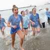 A group of kids run out of the bay waters for the Polar Plunge in San Francisco, Calif. on Saturday, March 4, 2023.