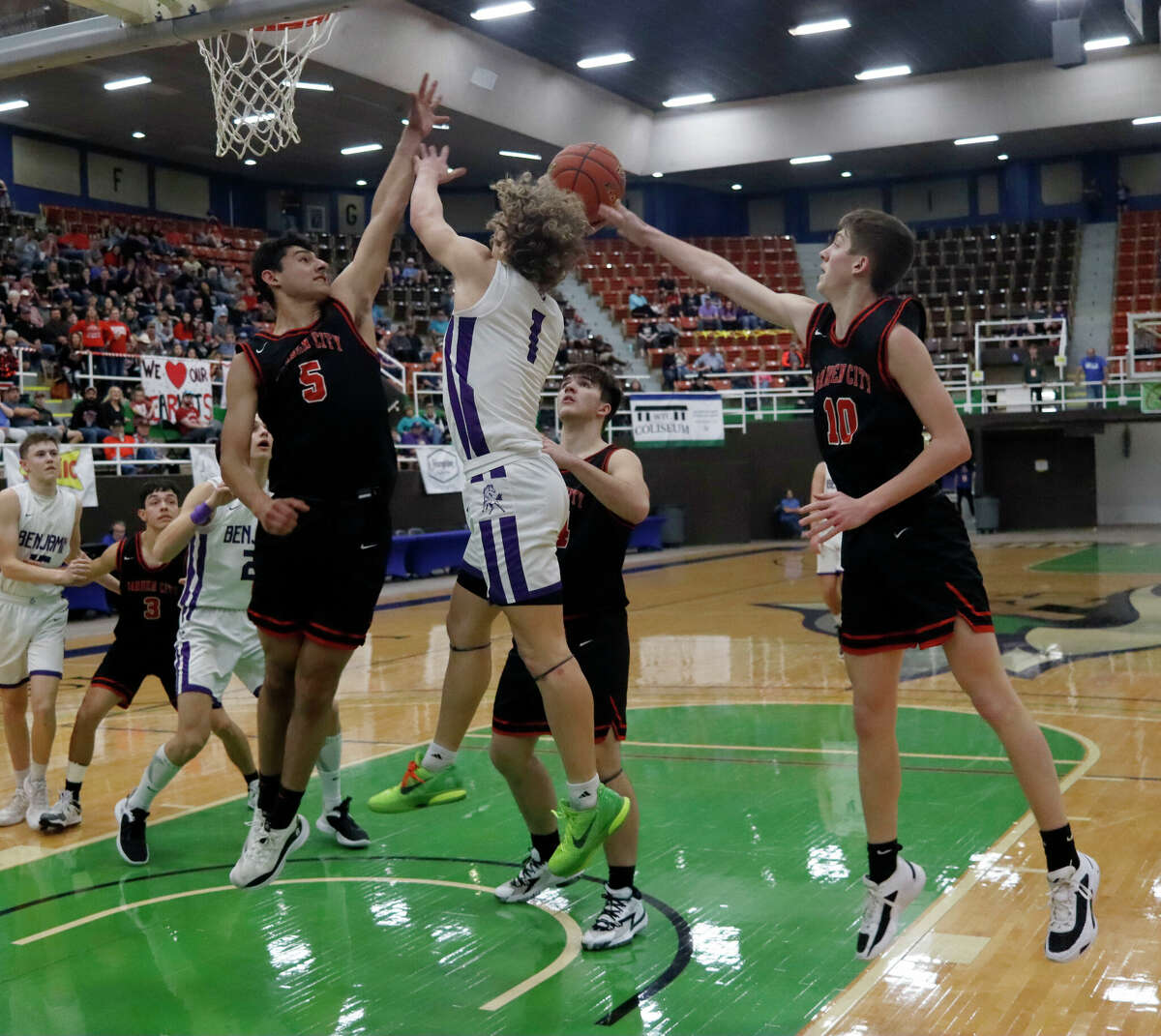 Benjamin's Grayson Rigdon (1) drives to the basket as Garden City's Julio Talamantes (5) and Texas Brinkley (10) defend during the Region II-1A final at The Colseum in Snyder on 3/4/2023