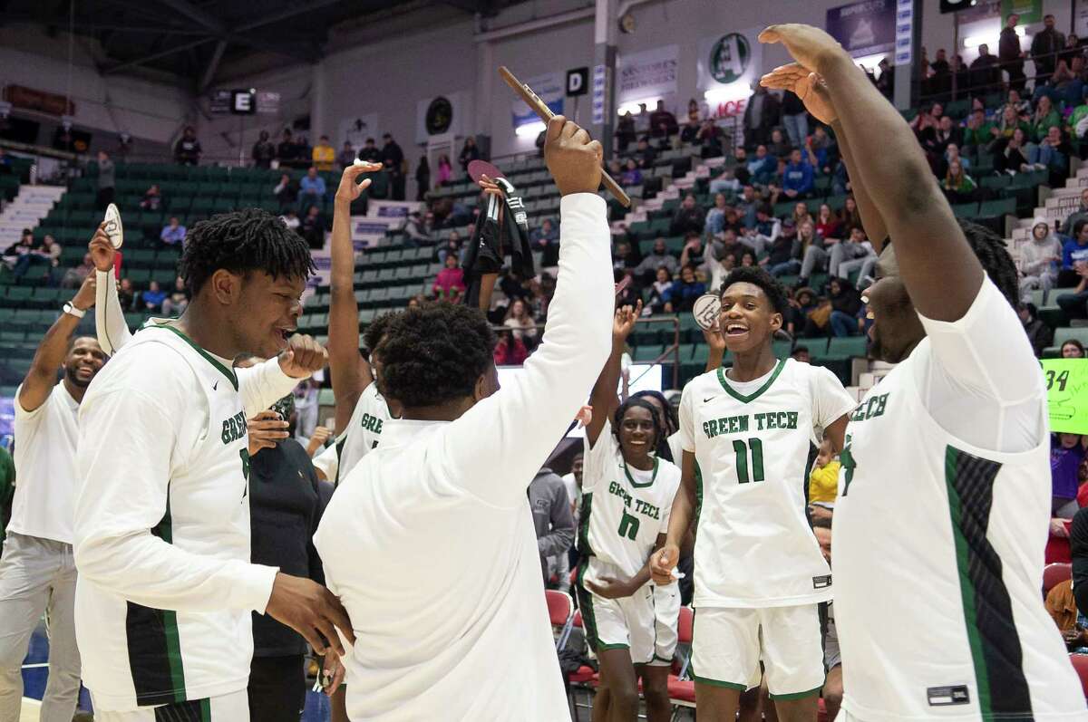 Green Tech coach DJ Jones holds up the Section II champions plaque following the team’s victory over CBA in the Class AA title game at Cool Insuring Arena in Glens Falls, N.Y. on Saturday, Mar. 4, 2023.