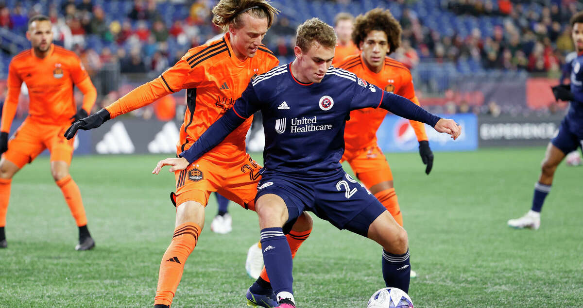 New England Revolution midfielder Noel Buck (29) fends off Houston Dynamo defender Griffin Dorsey (25) during a match between the New England Revolution and the Houston Dynamo Football Club on March 4, 2023, at Gillette Stadium in Foxborough, Massachusetts. (Photo by Fred Kfoury III/Icon Sportswire via Getty Images)