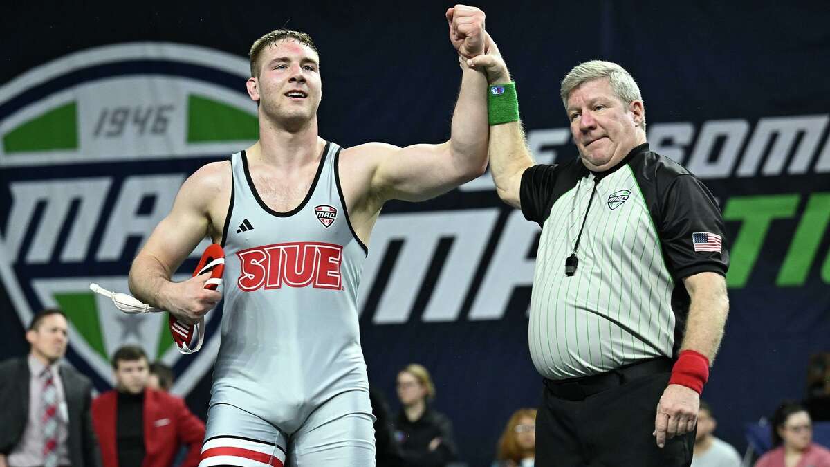 SIUE's Colton McKiernan raises his arms in victory for the Cougars. The senior heavyweight became the first SIUE wrestler to win a MAC individual title after defeating Northern Illinois' Terrese Aaron 2-0 in the championship match Saturday at EagleBank Arena.