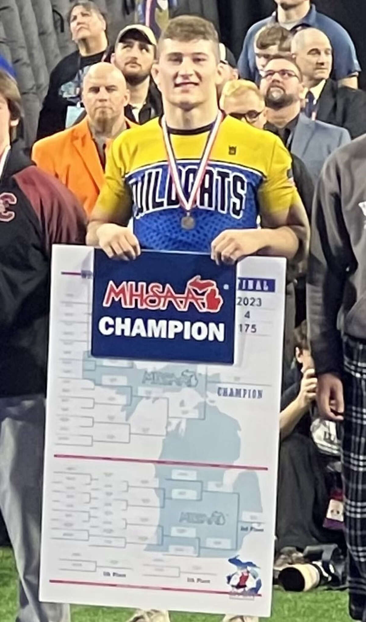 Evart's Cole Hopkins was presented with his wrestling state championship medal and bracket sign at the award presentation on Saturday, March 4, at Detroit's Ford Field.
