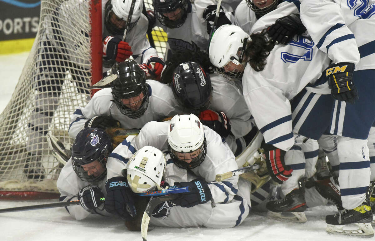 Southingtin/Avon co-op players celebrate after defeating New Canaan in the CHSGHA girls ice hockey semifinals at the Rinks at Shelton on Saturday, March 4, 2023.