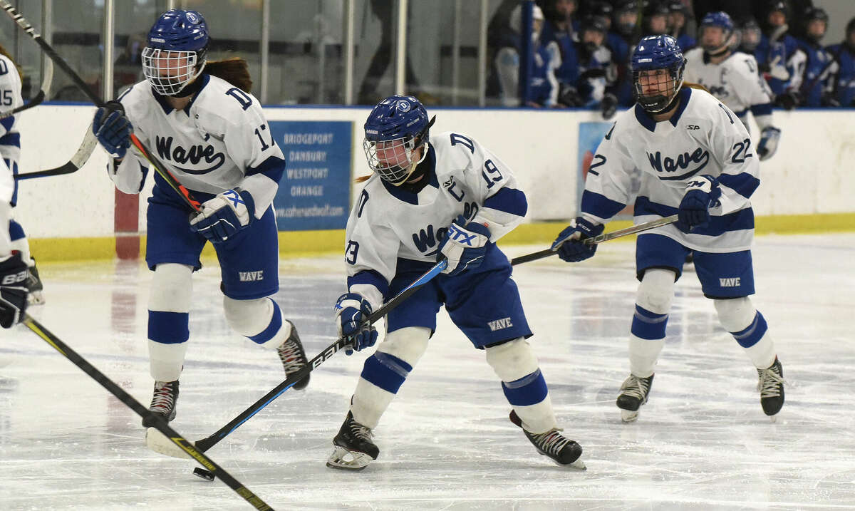 Darien's Chelsea Donovan (19) looks to pass against East Catholic during the CHSGHA girls ice hockey semifinals in Shelton on Saturday, March 4, 2023.