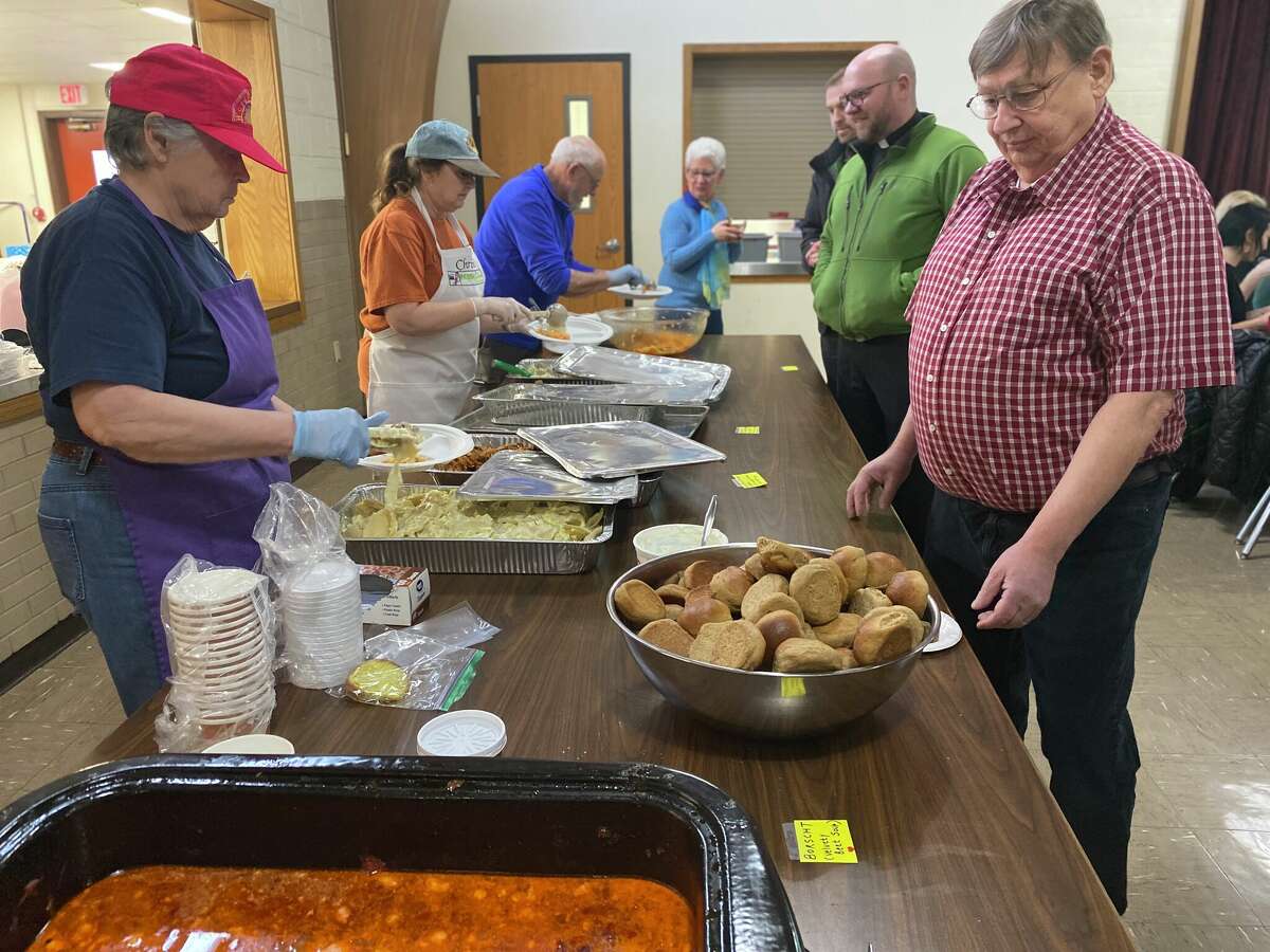 Volunteers serve authentic Ukrainian dishes to guests at the Global Compassion, Inc. fundraiser dinner, March 4 at the Blessed Sacrament Parish.