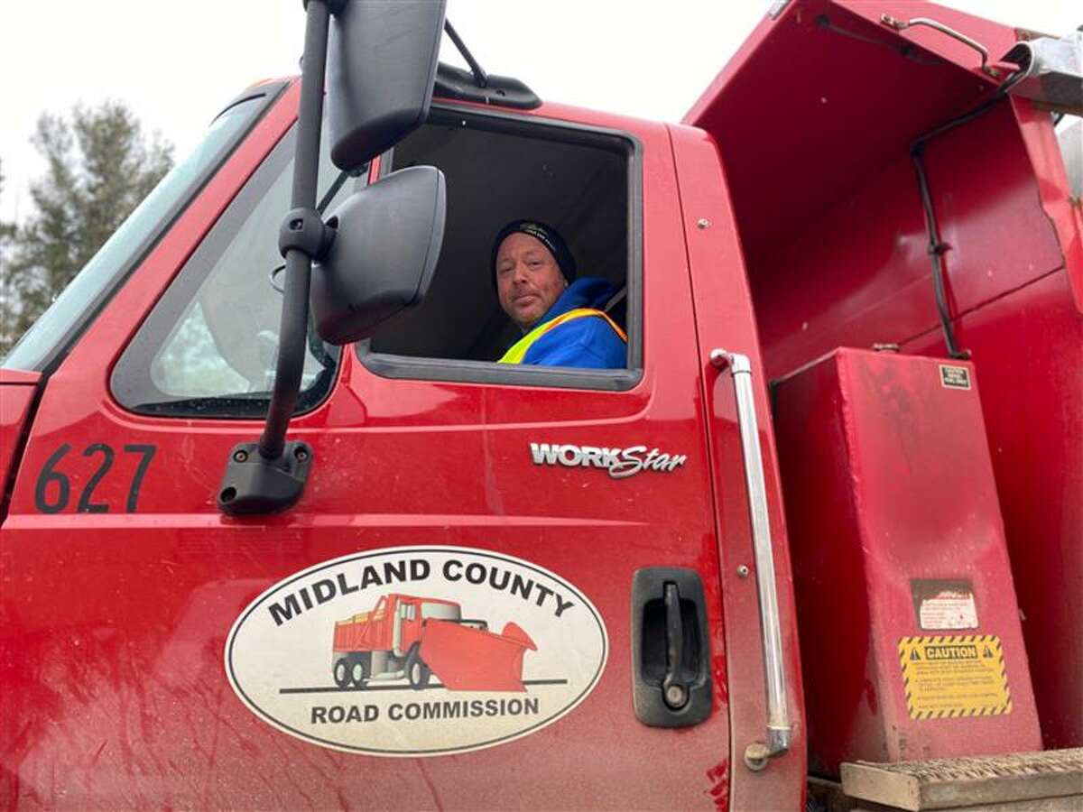 Jess Crowder sits in his county snow plow truck on March 2 at the Midland County Road Commission.