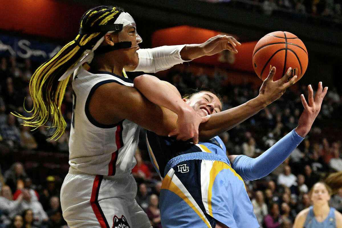 Connecticut's Aaliyah Edwards (3) and Marquette's Chloe Marotta (52) fight for a rebound during the first half of an NCAA college basketball game in the semifinals of the Big East Conference tournament at Mohegan Sun Arena, Sunday, March 5, 2023, in Uncasville, Conn. (AP Photo/Jessica Hill)