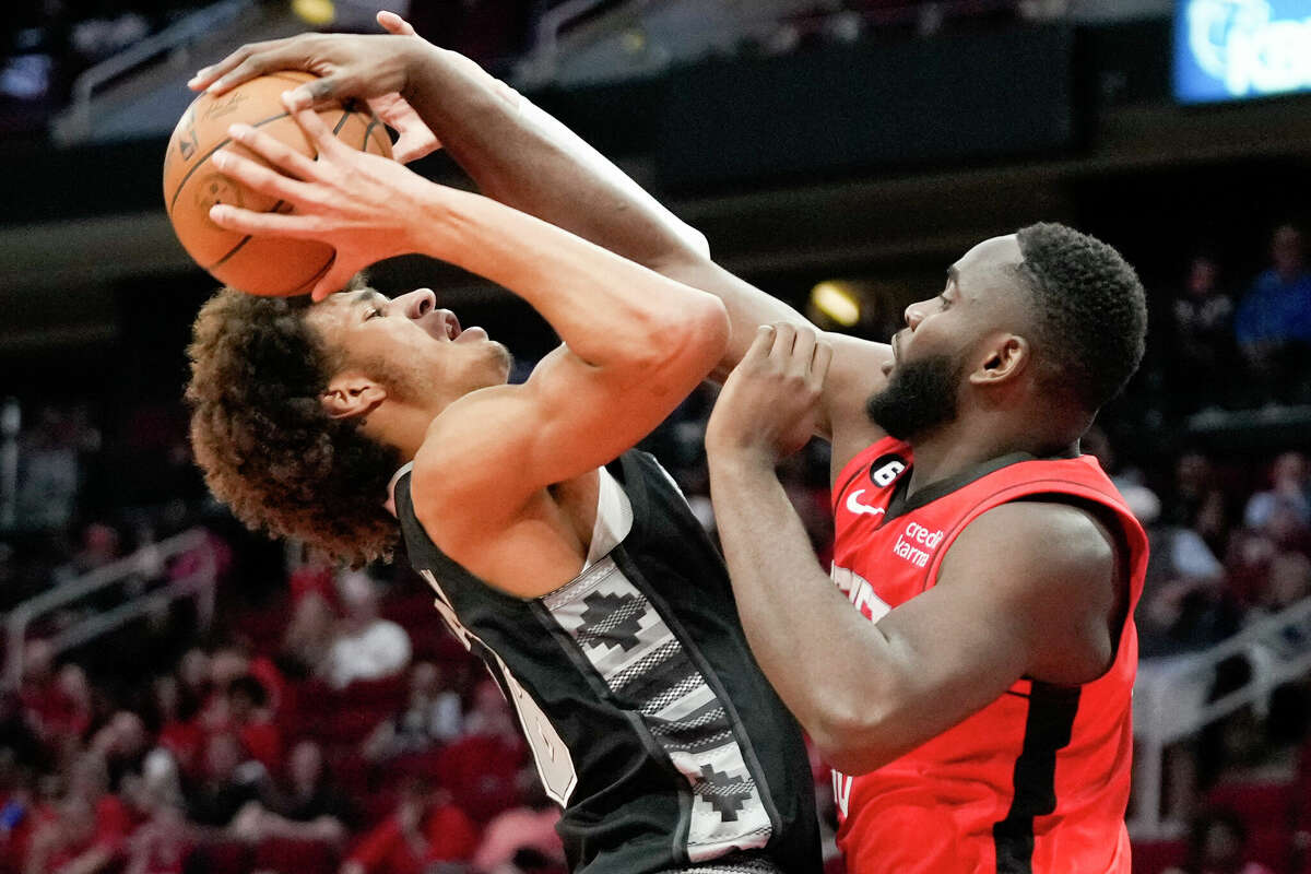 San Antonio Spurs forward Dominick Barlow, left, is fouled by Houston Rockets forward Usman Garuba during the first half of an NBA basketball game, Sunday, March 5, 2023, in Houston. (AP Photo/Eric Christian Smith)