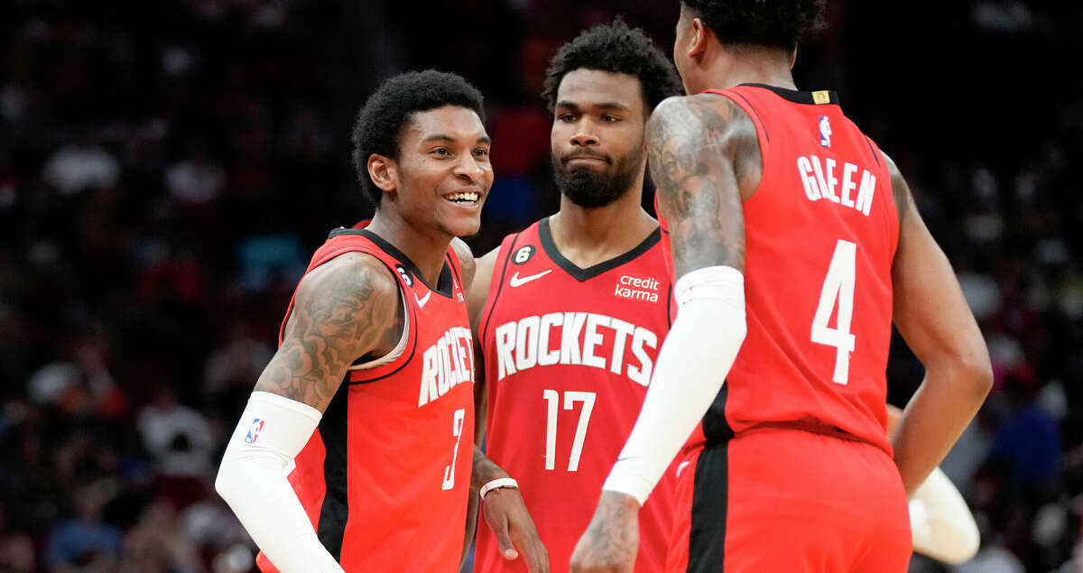Houston Rockets guard Kevin Porter Jr., left, celebrates after his 3-point basket with Tari Eason (17) and Jalen Green (4) during the first half of an NBA basketball game against the San Antonio Spurs, Sunday, March 5, 2023, in Houston. (AP Photo/Eric Christian Smith)