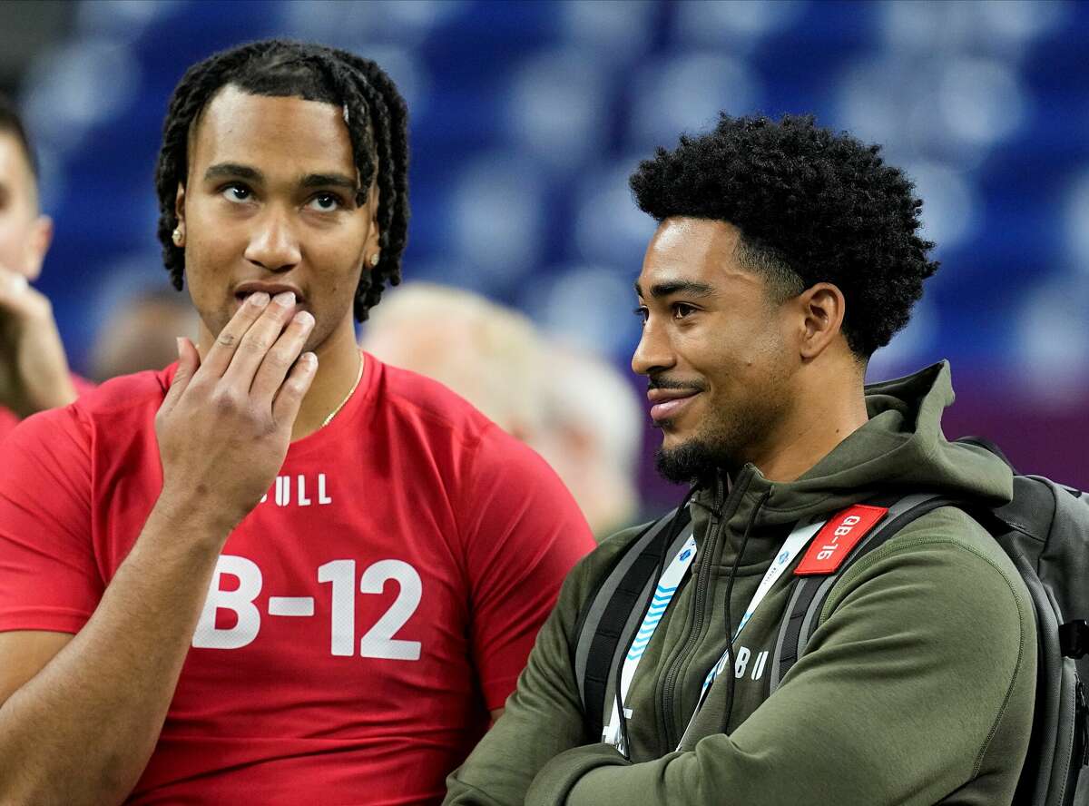 Ohio State quarterback C.J. Stroud, left, and Alabama QB Bryce Young share a moment at the NFL combine in Indianapolis on Saturday.