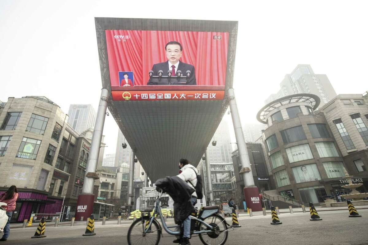 A screen displays a news broadcast of Li Keqiang, China's premier, during the opening of the First Session of the 14th National People's Congress (NPC) at the Great Hall of the People in Beijing, on Friday, March 5, 2023.