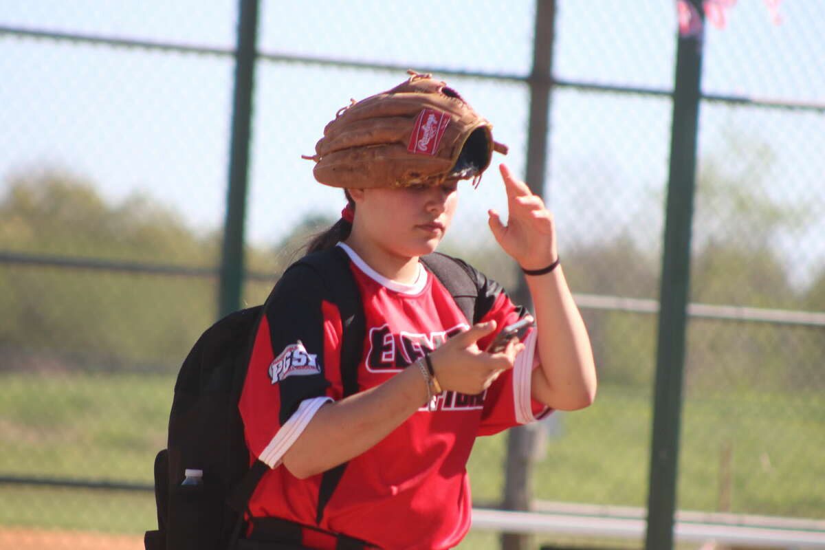 Maya Sermeno found an unusual use for her glove after one of numerous contests during PGSA's opening day Saturday.