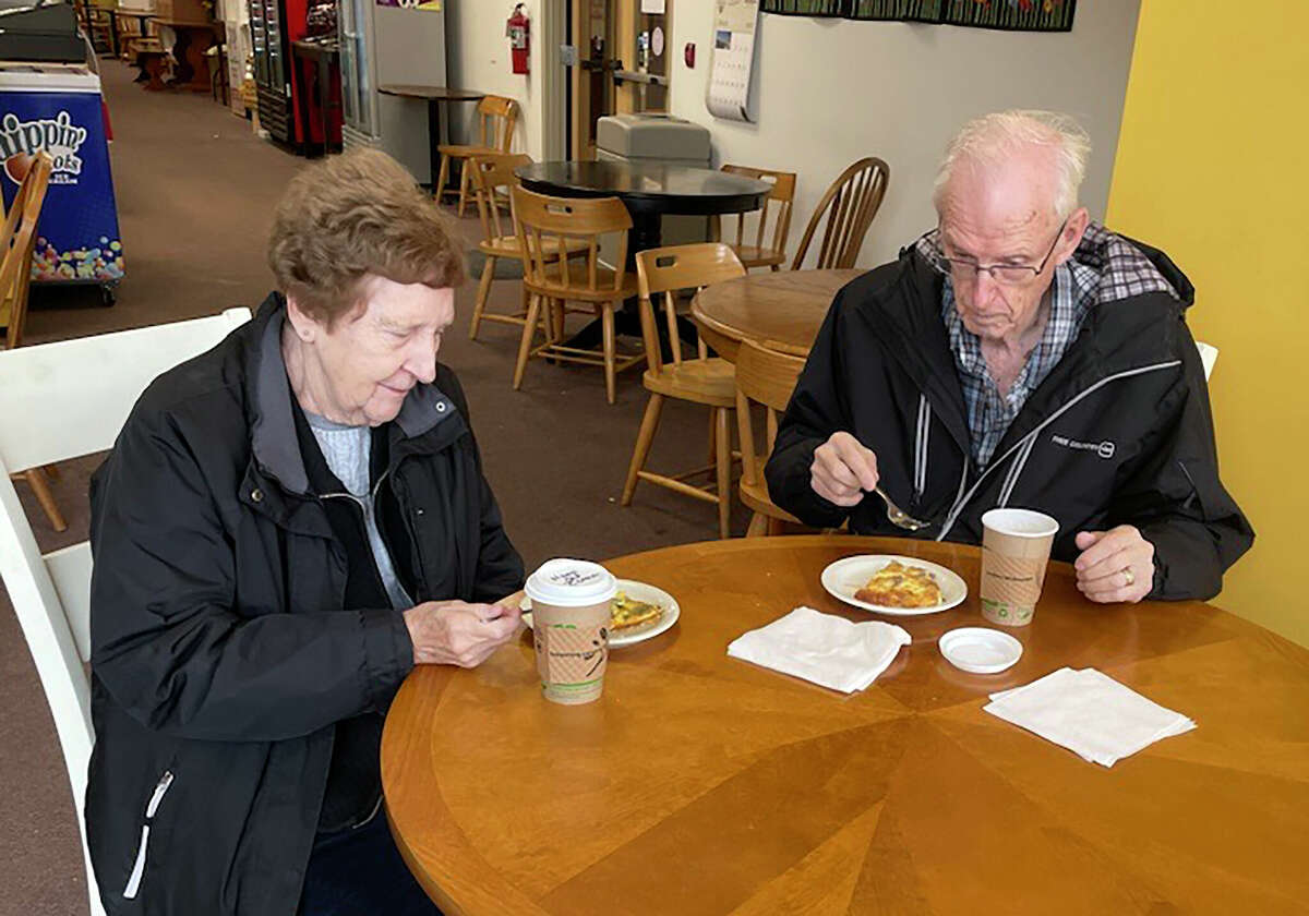 Retired teachers Don and Joan Totten enjoy a rare moment Monday by eating breakfast at Three Girls Bakery, 106 N. Michigan Ave. Joan Totten said, "It's a very rare thing for us because we retired and get lazy." Don Totten replied, "She cooks, I'm lazy."