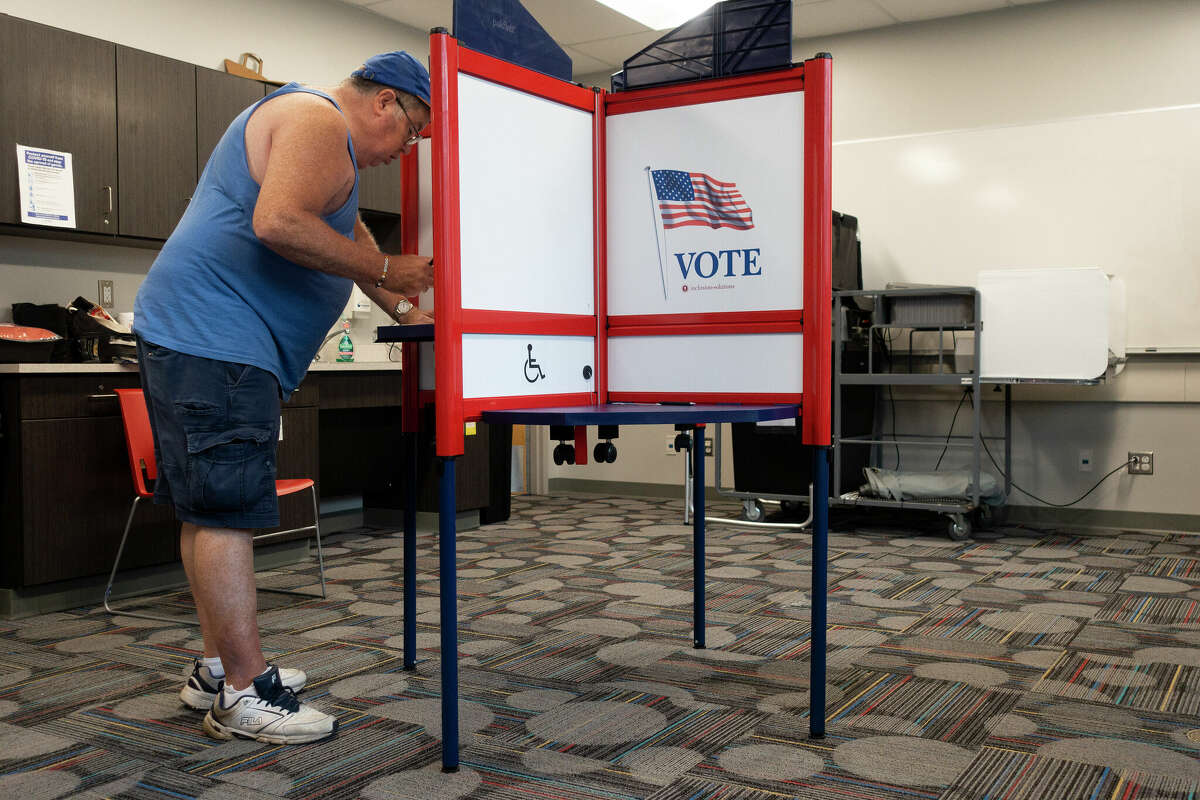 Harold Reedy Jr. fills out his ballot during primary voting at the Phyllis Bornt Branch Library on Tuesday, Aug. 23, 2022, in Schenectady, N.Y.