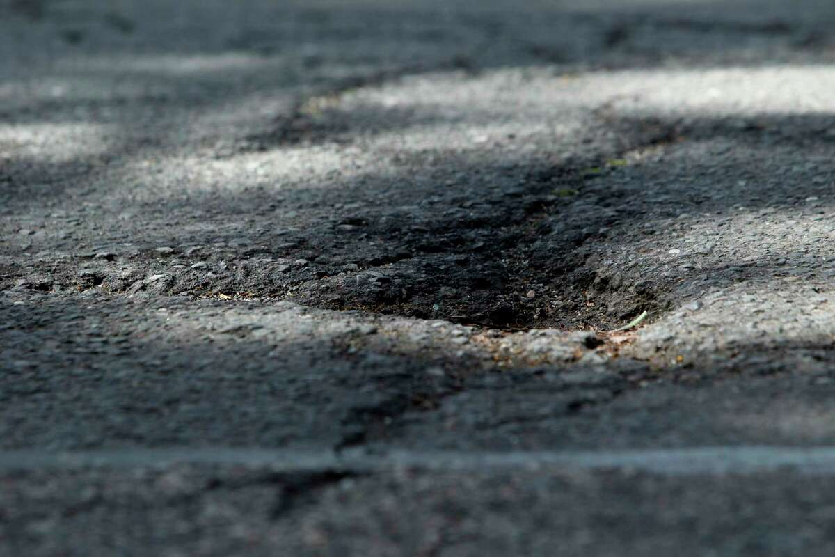 Cracks and potholes are seen at Franklin Street and Golden Gate Avenue in 2015. California’s winter storms have caused an increase in potholes in San Francisco. 