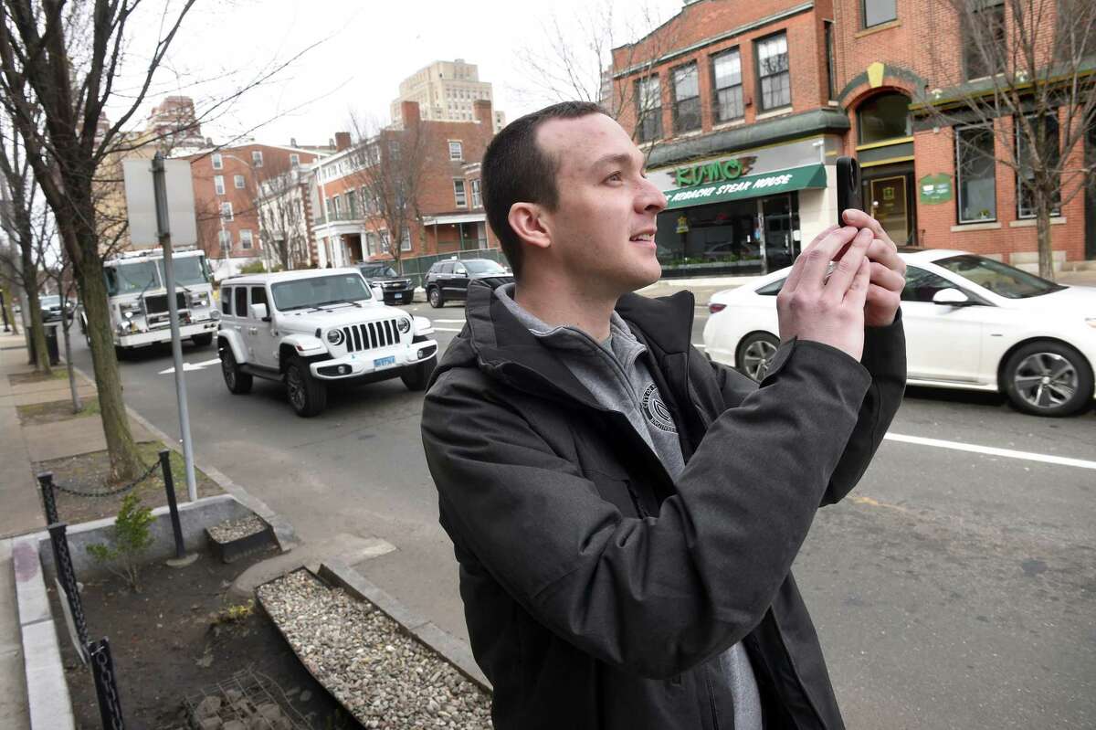 Adam Weber, project manager for the New Haven Engineering Department, films the intersection of Elm and State Street in New Haven for an @EverydayEngineering TikTok video explaining the "No Turn On Red" signs on March 6, 2023.