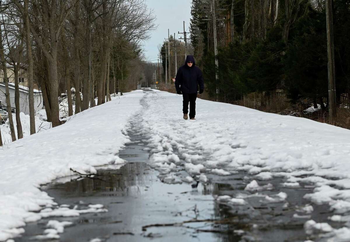 Snow covers segments of the Albany County Rail Trail near Delaware Ave., as hikers tread a path through the slush on Monday, March 6, 2023, Bethlehem, N.Y.