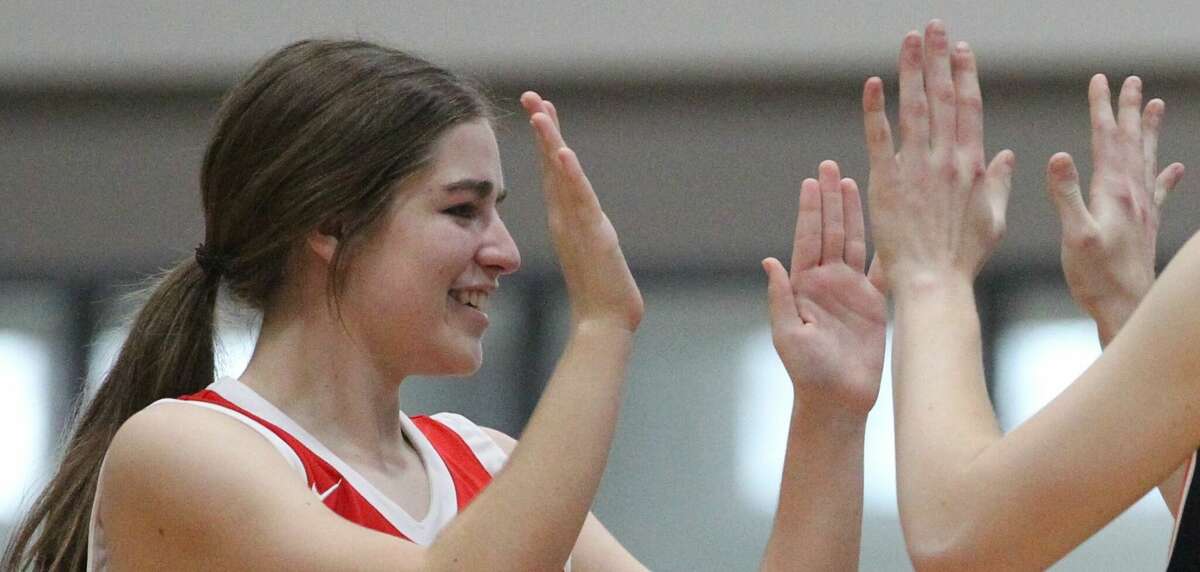 Jacksonville's Tate Morrisey greets teammates one last time at Sunday’s Westown Ford Lincoln Senior Girls All-Star Basketball Game at Illinois College.