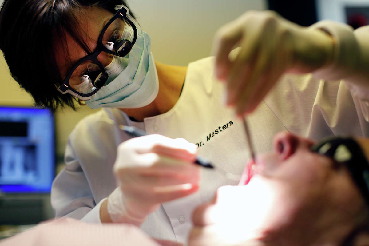 Dr. Lisa Masters checks a patient's mouth during a routine check up Monday, May 4, 2009 in San Antonio.