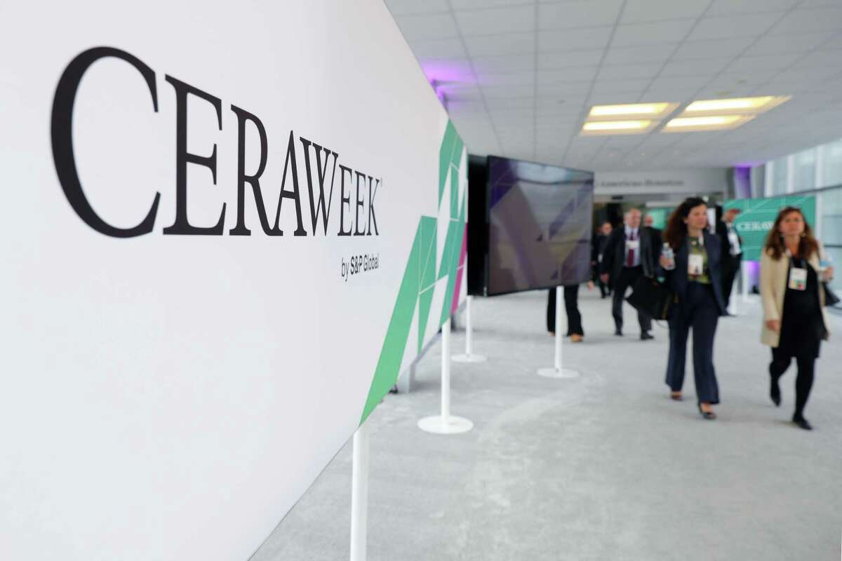 Attendees cross the skybridge between the Hilton Americas and George R. Brown Convention center during the first day of CERAWeek 2023 Monday, March 6, 2023 in Houston.