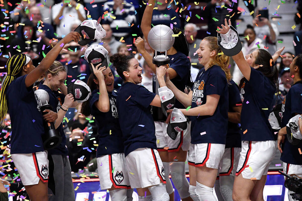 UConn's Lou Lopez Senechal, center left, and Dorka Juhasz, center right, hold the Big East Championship trophy as they celebrate with teammate after defeating Villanova in an NCAA college basketball game in the finals of the Big East Conference tournament at Mohegan Sun Arena, Monday, March 6, 2023, in Uncasville, Conn. (AP Photo/Jessica Hill)