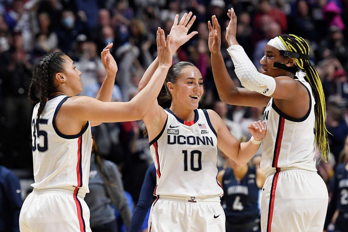 UConn's Azzi Fudd (35), Nika Muhl (10) and Aaliyah Edwards celebrate after their win over Villanova in an NCAA college basketball game in the finals of the Big East Conference tournament at Mohegan Sun Arena, Monday, March 6, 2023, in Uncasville, Conn. (AP Photo/Jessica Hill)